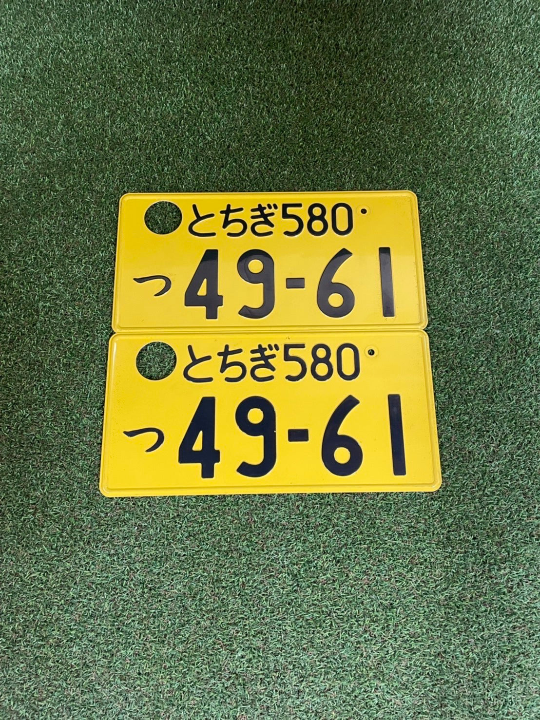 Genuine used JDM number plate pair - 580/49-61